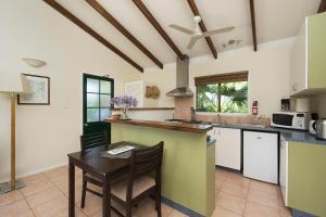 a kitchen with a table and a counter top at Hillcrest Mountain View Retreat in Crystal Creek