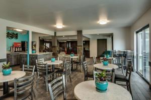 a restaurant with tables and chairs with plants on them at SureStay Plus Hotel by Best Western Post Falls in Post Falls