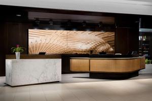 a lobby with a reception desk with a marble counter at Hyatt Centric Arlington in Arlington