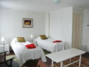 Habitación con 2 camas y mesa. en Villa Dönsby en Karjaa