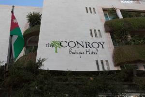 a building with a sign for the comagency boutique hotel at The Conroy Boutique Hotel in Amman