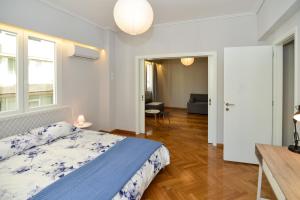 a bedroom with a bed and a living room at Athens' heart Syntagma metro apartment in Athens