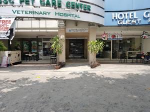a hotel center with palm trees in front of it at Hotel Giorgio in General Santos