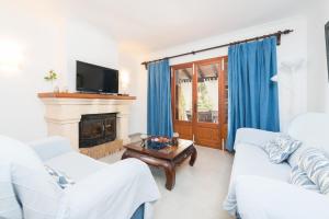 a living room with two white couches and a fireplace at Can Caimari in Cielo de Bonaire 