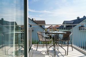 a balcony with a table and chairs on it at Come IN Comfort in Ingolstadt