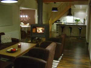 a living room with a fireplace and a table at La Brindille in Durbuy