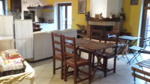 スーザにあるRelais des Alpesの部屋に木製のテーブルと椅子が置かれたキッチン