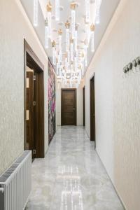 a hallway with a large chandelier in a building at Sweet Home 6 VIP at Rustaveli Avenue in Tbilisi City