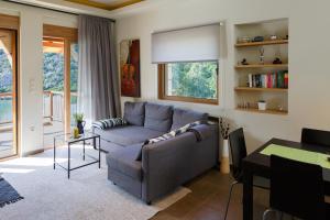 a living room with a couch and a table at Into The Blue Apartment in Áyios Andréas