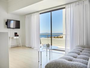 a living room with a couch and a view of the ocean at La Splendida Hotel by NEWMARK in Cape Town