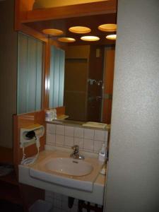 a bathroom with a sink and a mirror at Kinparo in Kyoto