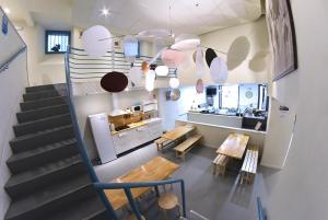 a room with a staircase and a kitchen with a table at Plaza Catedral hostel in Pamplona