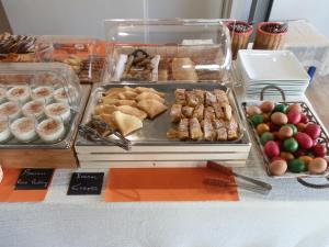 a buffet of food with pastries and other foods on a table at Philoxenia in Kalabaka