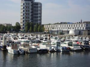 a group of boats docked in the water in a harbor at Au cèdre bleu in Saint-Martin-Boulogne