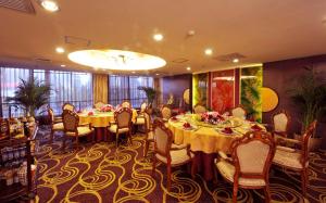 a restaurant with long tables and chairs and a large window at Super House International in Beijing