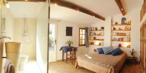 a bedroom with a shower and a bed in a room at Chambres d'Hotes Domaine des Machottes in Grans