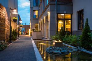 a building with a fountain in the middle of a street at Golden Tulip Krakow Kazimierz in Krakow