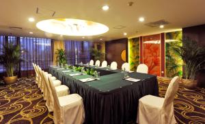 a conference room with a long table and white chairs at Super House International in Beijing
