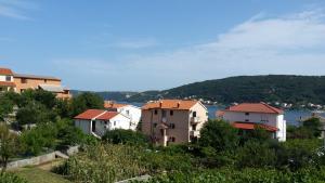 a group of houses on top of a hill at Guesthouse Familija Tariba in Supetarska Draga