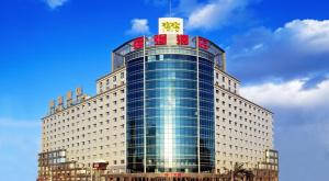 a large building with a clock on top of it at Super House International in Beijing