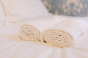 a roll of towels sitting on top of a bed at Watson Crescent in Edinburgh