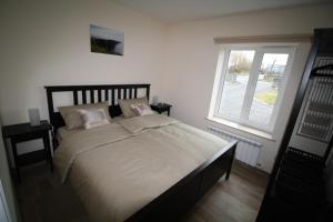 a bedroom with a large bed with a window at Atlantic Retreat Lodge in Kinvara