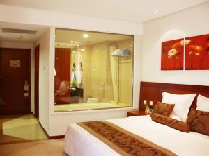 a hotel room with a large bed and a bathroom at Super House International in Beijing