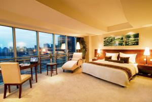 a hotel room with a bed and a desk and a desk at Super House International in Beijing