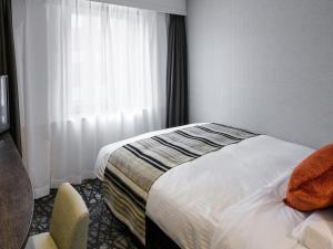 
Tempat tidur dalam kamar di Hotel Mystays Kagoshima Tenmonkan
