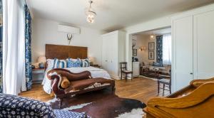 a bedroom with a bed and a couch in it at Drostdy Hotel in Graaff-Reinet +183 photos