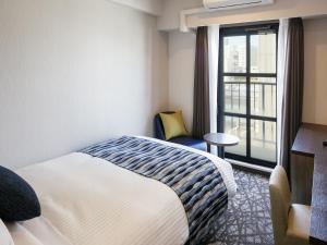 Letto o letti in una camera di Hotel Mystays Kagoshima Tenmonkan Annex
