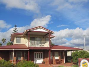 a large house with a balcony on top of it at Ocean View Retreat in Jurien Bay