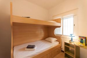niewielka sypialnia z łóżkiem piętrowym i biurkiem w obiekcie Lets Holidays Elsa apartment w Tossa de Mar