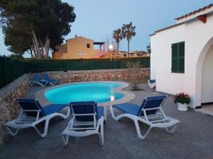 a patio with two chairs and a swimming pool at Villa Samba in Cala en Blanes