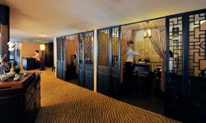 a room with blue doors and people in a room at Super House International in Beijing