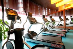 a row of cardio machines in a gym at Super House International in Beijing