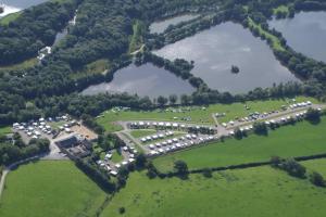 an aerial view of a parking lot with a lake at Wyreside Lakes Glamping Pods in Lancaster