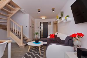 a living room with a couch and a table at Domki OAZA in Ostrowo