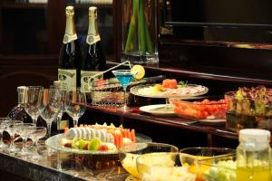 a buffet with plates of food and glasses of wine at Super House International in Beijing
