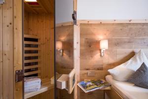 Habitación con pared de madera y puerta de cristal. en Appartements Am Achensee, en Pertisau