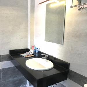 a bathroom with a sink and a mirror at Tam Coc Cozy Homestay in Ninh Binh +54 photos