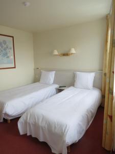Postel nebo postele na pokoji v ubytování Hotel Côte d'Opale