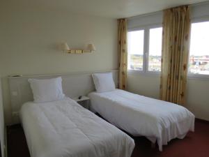 Postel nebo postele na pokoji v ubytování Hotel Côte d'Opale