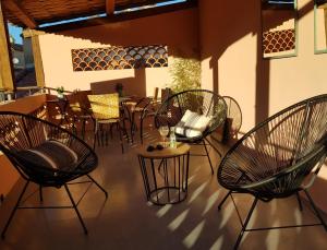 a patio with chairs and a table and a table and chairs at Les Lauriers in Saint-Tropez