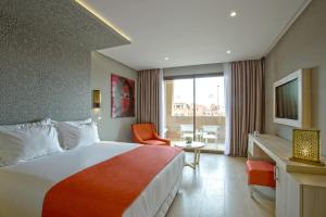 a hotel room with a large bed and a television at Be Live Collection Marrakech Adults Only All inclusive in Marrakesh +37 photos
