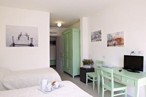 a room with a bed and a desk with a computer at LIù B&B in Torre del Lago Puccini