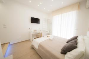 サレルノにあるシェリー B&B サレルノのベッドと机のある白い寝室