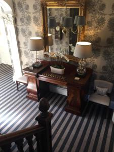 a room with a piano and a mirror at Glenburnie House in Oban