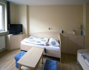 Dormitorio pequeño con cama y mesa en BODY penzion en Brno