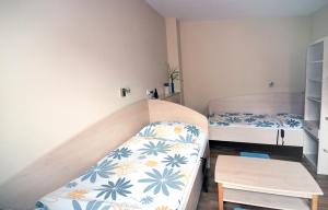 ブルノにあるBODY penzionのベッド2台と階段が備わる小さな客室です。